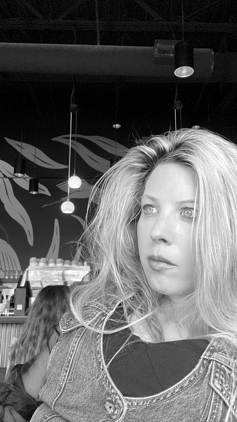 Jennifer in a denim outfit, photographed in a café